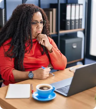 Businesswoman doing research on her laptop in an office