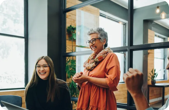 Business people smiling cheerfully during a meeting in a modern office
