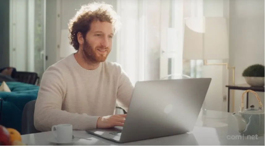 Small business owner searching for available domain names on laptop